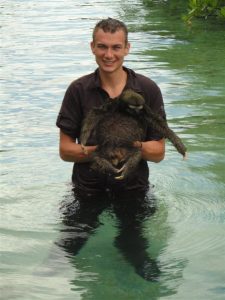 bryson holding sloth in water